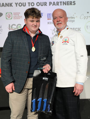 Ollie receives the Welsh Apprentice Butcher of the Year award from Colin Gray, CAW chairman of judges.