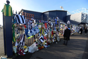 Tributes are placed on the gates during the memorial service for Cyrille Regis at The Hawthorns