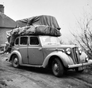 Dennis Foxall of Bridgnorth about to make a delivery, believed to be of a mattress and wardrobe, carried on top of his car, circa 1950s. The picture is from the late Dennis's son Frank Foxall, who said: 'My dad was Dennis Foxall and the business included furniture, wallpaper, paints, home decoration, and fishing tackle. He used to sell furniture and I reckon that that's a mattress, and that that on top is a single wardrobe. He didn't have a van. He always bought a car that could take the load. I can vaguely remember it. I think it was blue. This was the last car before he bought an Austin. I can't tell you what sort of car this one is. A Wolseley? In the background is my dad's house, where I was born. That's West Grove, on The Grove at Bridgnorth.' The business was just on the right at the junction with Cartway when coming over Bridgnorth bridge towards High Town.