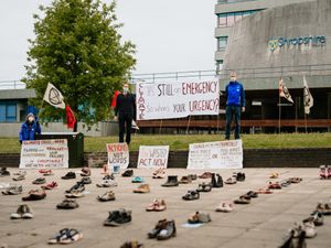 Supporting image for story: 100 pairs of shoes outside Shropshire Council HQ as climate activists mark anniversary of climate emergency declaration