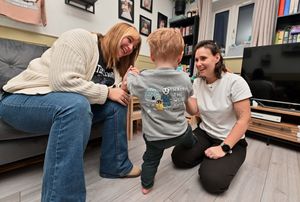 Jade and Hollie with their son Beck as he models one of the outfits