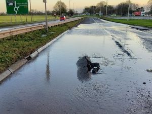 Supporting image for story: Repair work continuing as burst water pipe floods A41