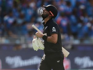 New Zealand’s Daryl Mitchell reacts as he walks off the field after losing his wicket during the ICC Champions Trophy final against India