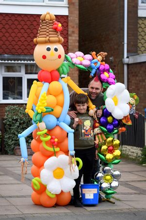 Balloon modeller Ricky Tarbuck and son Ellis, aged 9, with their creation.
