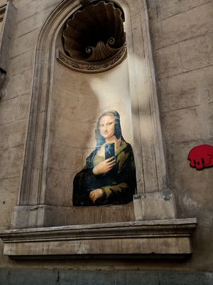 Mona Lisa takes a selfie on one of the many examples of 'street art' murals around the city