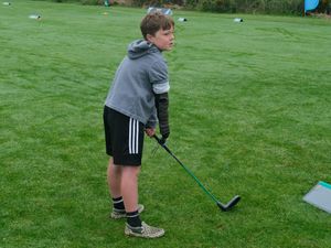 Supporting image for story: Boy with limb difference ‘excited’ to play golf with grandfather thanks to tool