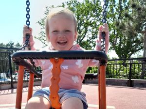 Annabel Mackey on a swing, smiling