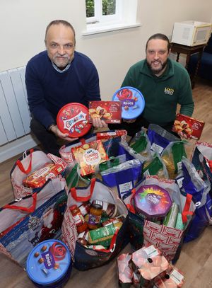 Lock Stock Self Storage Area Manager Alan Brightmore hands over a consignment of Christmas goodies to Paul Kemp at Ludlow’s Stephen House, the St Laurence’s Church town centre hub that helps vulnerable people