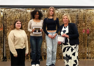 The hospital team received their award from Burton Borough students Kezia Keating and Felicity Williams