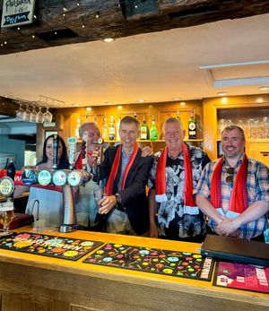 The ambassador behind the bar wearing Welsh colours at the Dolphin.