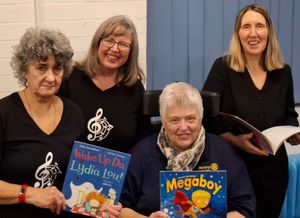 Members of "Singing, Cos We Like It" with Beverley Ricketts of Rotary Books4Home