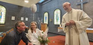 Emily and Jamie Cross with Reverend Martin McDonald