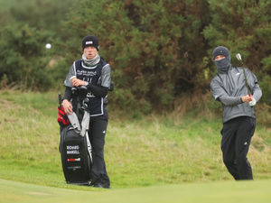 Supporting image for story: Staffordshire's Richard Mansell fights off the wind and rain