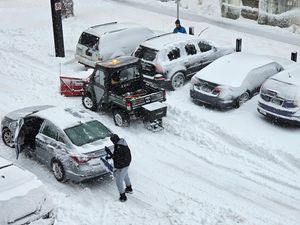 A snowplough helps free a stuck driver in Minneapolis