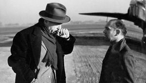 A chat for producer Paul Soskin and cameraman Osmond Borradaile during the shooting of the movie Signed With Their Honour at a Shropshire airfield in 1943.