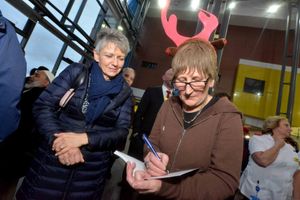 Doreen Tipton signs a book for Jan Bidmead
