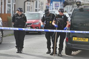 A police investigation team sweeped the streets for any remaining evidence