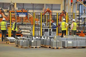 Workers inspect the robots used in the automotive service centre
