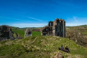 People looking out in the distance from the top of Clun Castle in 2015, making the most of the sunny weather.