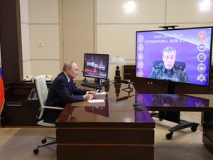 Russian President Vladimir Putin listens to Russian chief of general staff General Valery Gerasimov with the report that all Ukrainian troops have been forced from Russia’s Kursk region, during their meeting via video conference at the Novo-Ogaryovo residence outside Moscow
