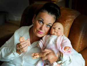 Jane Dunn, pictured holding Susan's life doll, says her sister Susan Hearsey, was abused and bullied at Walsall Manor Hospital by staff nurses.