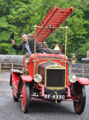 Transport manager Tim Shields driving an historic fire engine on show
