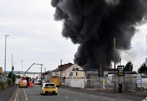 Black smoke pours into the sky from the fire at GB Tyres in West Bromwich. Photo: Tim Thursfield