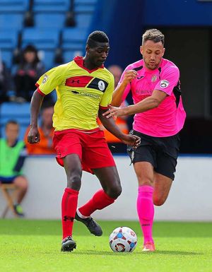 On-loan Walsall striker Amadou Bakayoko in the thick of the action against Stockport County.
