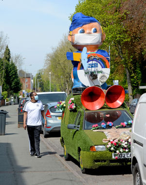 The grass-covered van now has a character on the top wearing a mask. A mask wearing passer-by spots it on Tettenhall Road