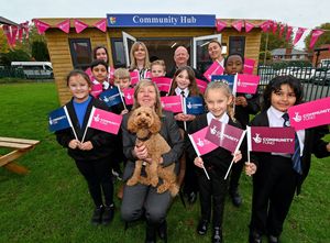 A new hub has been built at Field Road Academy, Walsall, which has been funded by the National Lottery. Headteacher Diane Newton, school dog Rufus, pupils and fellow staff members celebrate.