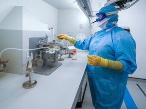 Staff work inside the AstraZeneca Laboratory in Macclesfield,