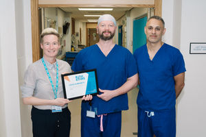 Stacey Keegan, Chief Executive, presenting Steve Humphreys with his RJAH Stars Award alongside Mr Rajpal Nandra, Consultant Orthopaedic Surgeon.