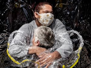Supporting image for story: Coronavirus hug image named World Press Photo of the Year