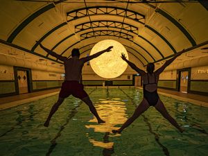 Supporting image for story: Sun artwork suspended above water at community swimming pool