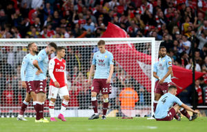 Aston Villa players appear dejected at the end of the Premier League match at the Emirates Stadium
