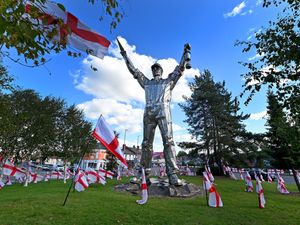 Supporting image for story: 'The town has a great history - let's be proud!' Residents react as Brownhills's Jigger statue island is covered by national flags
