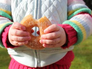 A child holding a donut