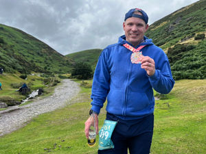 Supporting image for story: Nick crosses the finish line on his 400th marathon