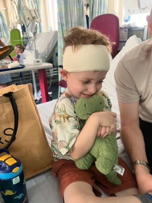 Ethan recovering with his favourite dinosaur