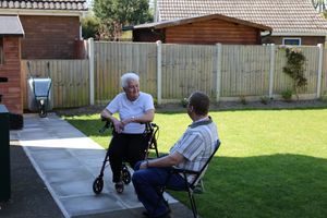 Marjorie enjoys a chat in her garden with her befriending volunteer, Jonathan.