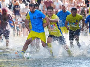 Supporting image for story: Annual river football clash goes ahead despite waterlogged pitch