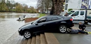 An image shows the black Audi A4 that was left dangling over the River Severn at Worcester Rowing Club on December 1 2025.