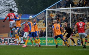 Tyrese Shade rises high to head the ball towards the Mansfield goal