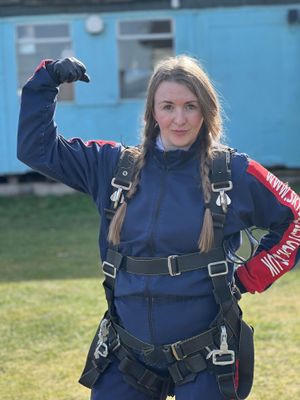 Louise Anne in the International Women's Day 2025 Accelerate Action pose before her skydive for Compton Care