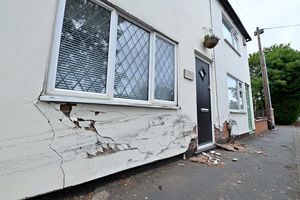 Cracks can be seen running along the foundations of the property 