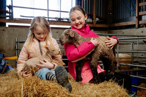 Abi Jones, 7, holding Tiny Tim who weighed just 4lbs when he was born, and older sister Isabella Jones, 9, with Hulk, who weighed a whopping 23lbs