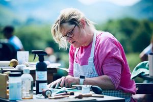 Concentrating very hard whilst carving the lino block.