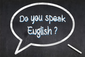 Blackboard with a bubble drawn in the middle with the short phrase "Do you speak English ?"