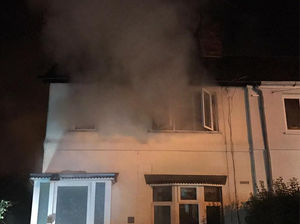 Smoke pours out of the window. Pictures from Willenhall Fire Station