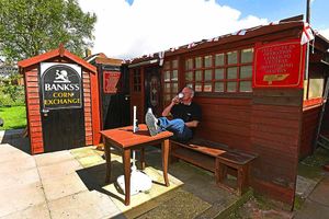 Relaxing in the sunshine, Steve enjoys a refreshing drink